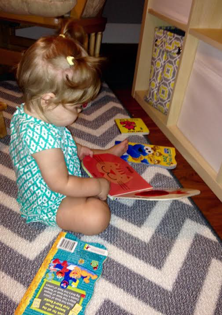 Sweet Pea looking at books