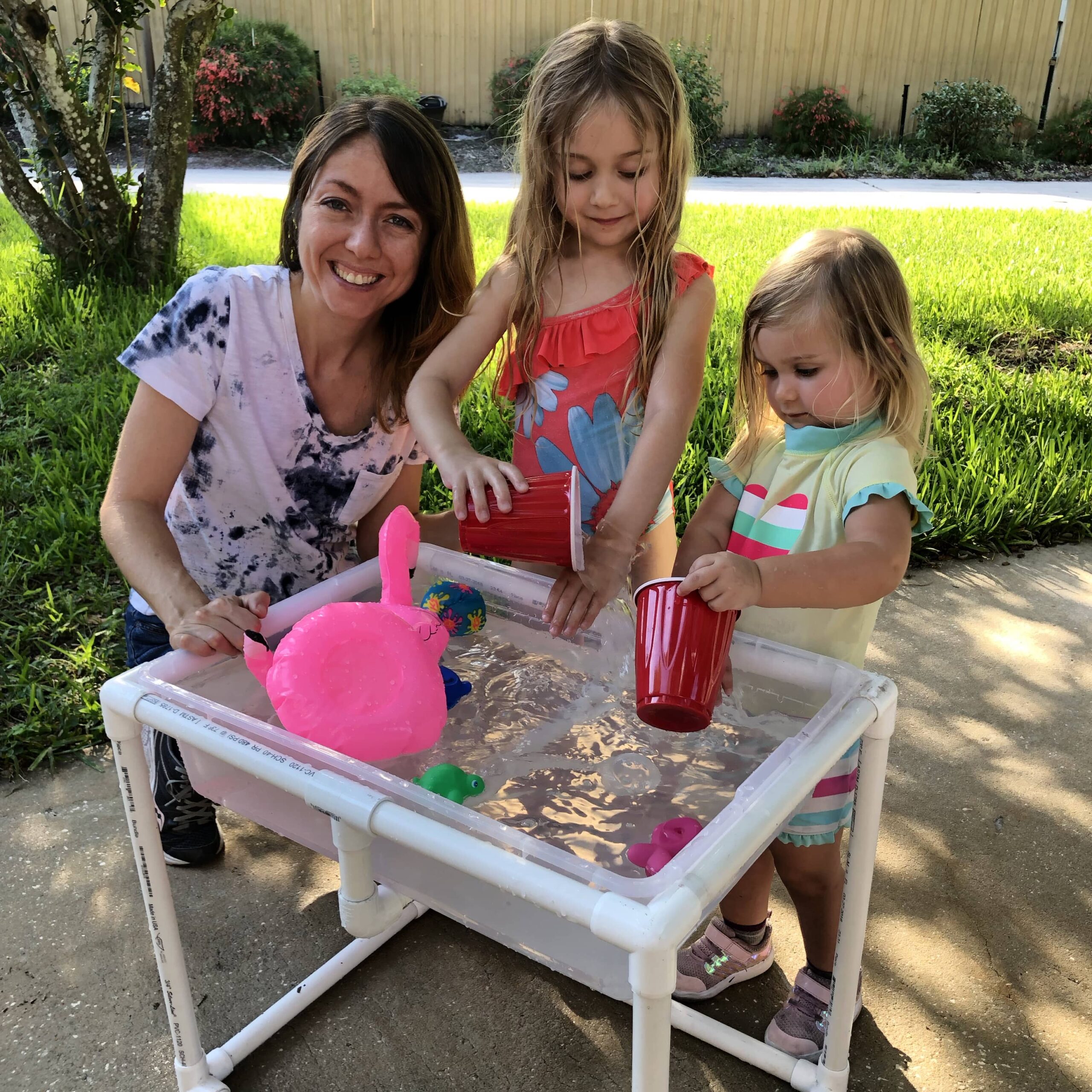 Miss Jen and the girls using a water table
